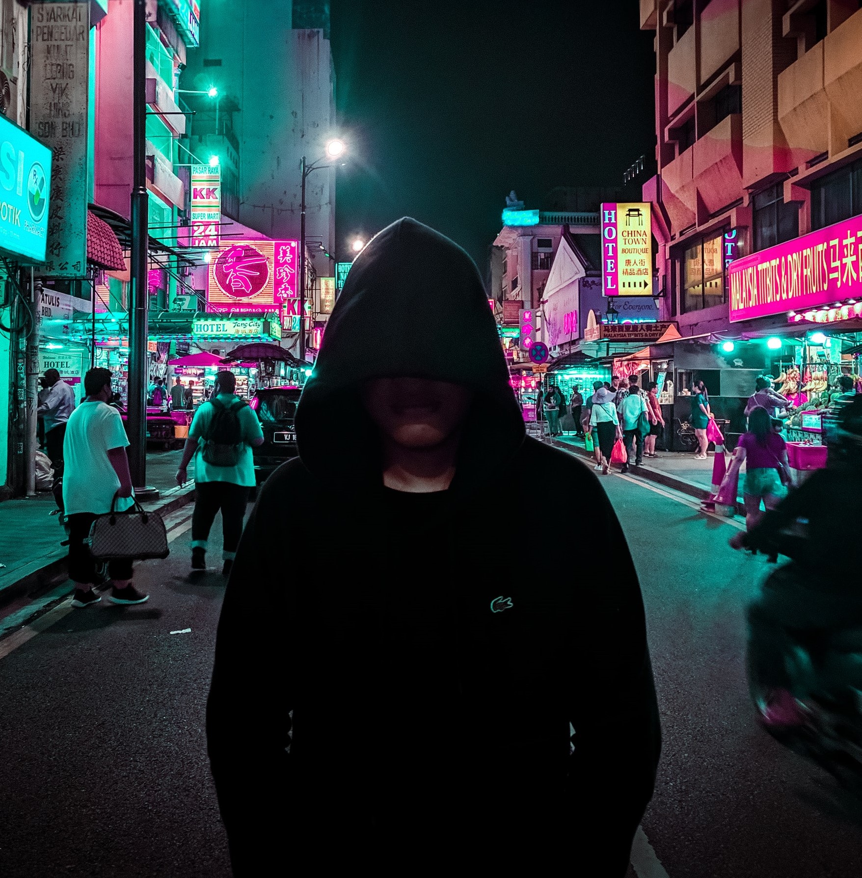 hacker in a hoodie walking down the street